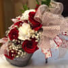 Red and white rose bouquet with a large polka-dot ribbon