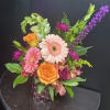 A large pale pink gerbera daisy paired with a smaller pink gerbera