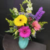 Three bold gerbera daisies-bright yellow, magenta, and soft pink-create an immediate burst