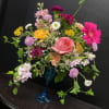 A large pink rose anchors this playful garden-style bouquet, a birthday bouquet