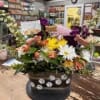 A lush, rounded memorial arrangement that brings warmth and color to a
