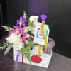 Small mixed bouquet in a gift box with a tag and ribbon