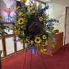 A standing spray with flowers as yellow as the sun and as