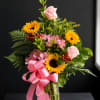 Radiating warmth and elegance, Golden Blush is a cheerful arrangement featuring bright