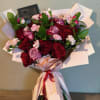 A passionate bouquet of pink roses and red roses to represent a