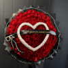 Round bouquet of red roses with a pearl heart and black ribbon