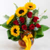 Bouquet of red roses and yellow sunflowers in a painted vase with a yellow ribbon