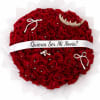 Heart-shaped bouquet of red roses with a white ribbon and jeweled accents