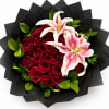 Bouquet of red roses and pink lilies wrapped in black paper