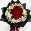 Red roses and white alstroemeria in black wrap with a red ribbon