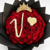 Red rose bouquet with a gold crown and white floral lettering