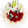 Bouquet of red roses and white lilies wrapped in cream paper