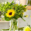 Yellow sunflower bouquet in a clear glass vase