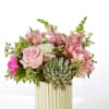 Pink and white floral arrangement with a succulent in a striped vase