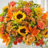 Bright bouquet of sunflowers, orange lilies, and coral roses