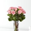Pink roses arranged in a clear glass vase