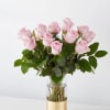 Pink roses arranged in a clear glass vase