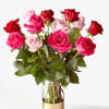Bouquet of pink and red roses in a clear glass vase
