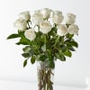White roses arranged in a clear glass vase