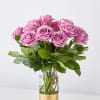 Pink roses arranged in a clear glass vase