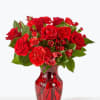 Red roses and carnations in a red glass vase