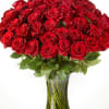 Large bouquet of red roses in a clear glass vase