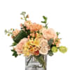 Peach and cream bouquet in a clear glass vase