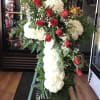 A classic sympathy Cross featuring fresh carnations accented with a beautiful line