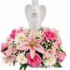 Pink and white floral arrangement with an angel figurine centerpiece