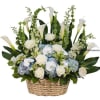 Tall white and blue flower arrangement with calla lilies and roses in a woven basket