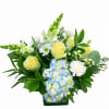 Yellow roses and blue hydrangeas in a glass vase