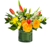 Yellow and orange flowers arranged in a clear glass vase