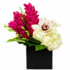 Pink and white flowers arranged in a black square vase