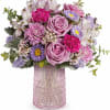 Pink and lavender mixed bouquet in a textured glass vase
