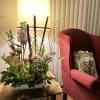 Mixed floral arrangement in a white rectangular container on a table