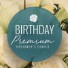 White calla lilies behind a birthday premium designer's choice label