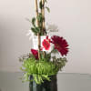 Red gerbera and roses with white daisies and green chrysanthemums arranged vertically