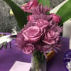 Lavender and pink roses with purple chrysanthemums and green foliage in a