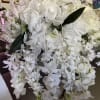 Large white floral arrangement with cascading blooms and pale pink accents