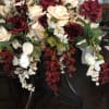 Large arrangement of red and white roses with cascading white orchids