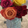 Four roses in a glittery blue vase