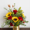 Red roses and sunflowers in a gold vase
