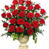 A beautiful Grecian urn filled with red roses and greenery. This funeral