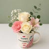 A charming Mother&rsquo;s Day arrangement featuring cream roses, a pink carnation, delicate