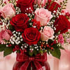 A romantic arrangement of rich red and soft pink roses accented with