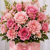 A lush mix of pink roses and coordinating seasonal blooms, beautifully arranged