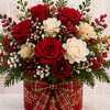 A beautiful arrangement of fresh red and white roses with seasonal accent