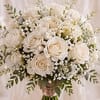 Ivory-white roses gathered into a full, rounded bouquet make an unforgettable wedding