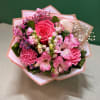 A charming grab-and-go floral arrangement featuring a premium rose, alstroemeria, carnations, snapdragons