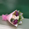 Pink-wrapped bouquet with white roses and purple chrysanthemums